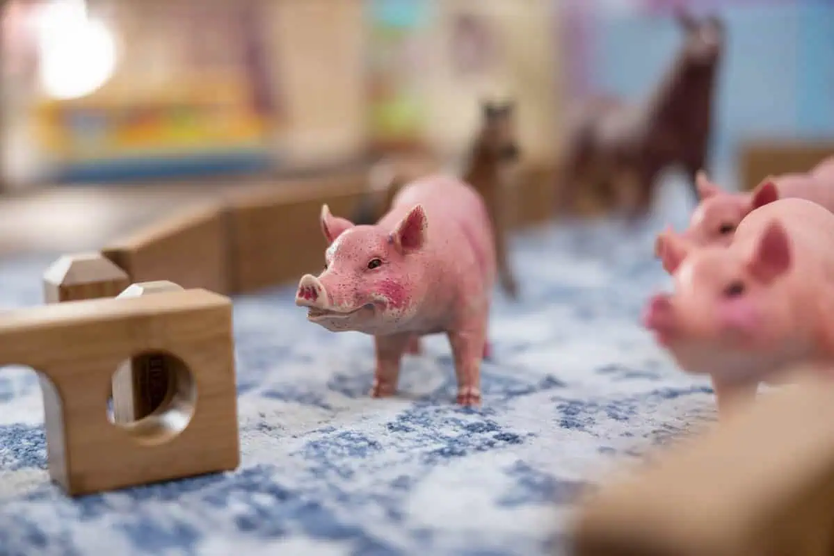 Cute piglet toys in a children's play area at Monkey Puzzle Kingston.
