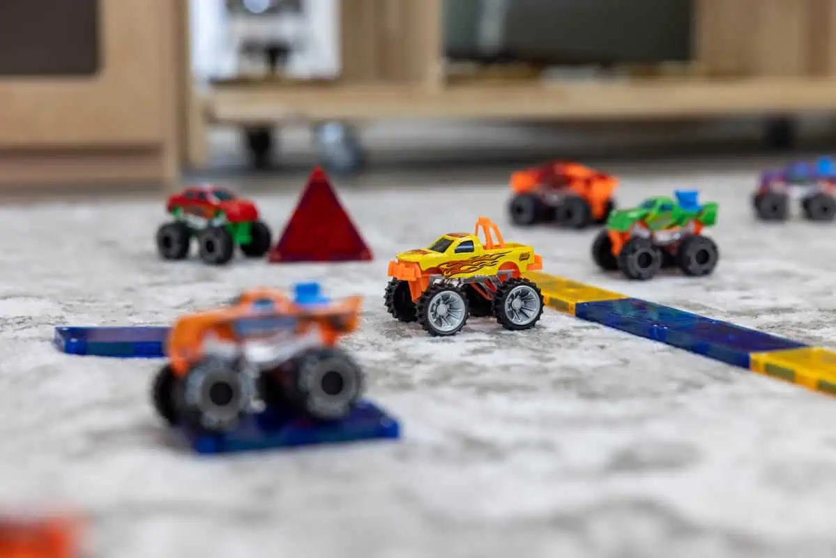 Colorful toy cars and blocks on a play mat at Monkey Puzzle Kingston.