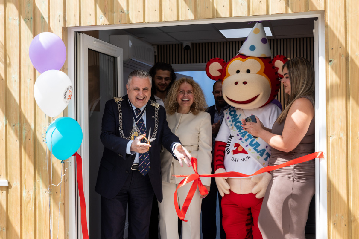 Grand opening of Monkey Puzzle Day Nursery Kingston with ribbon cutting ceremony.
