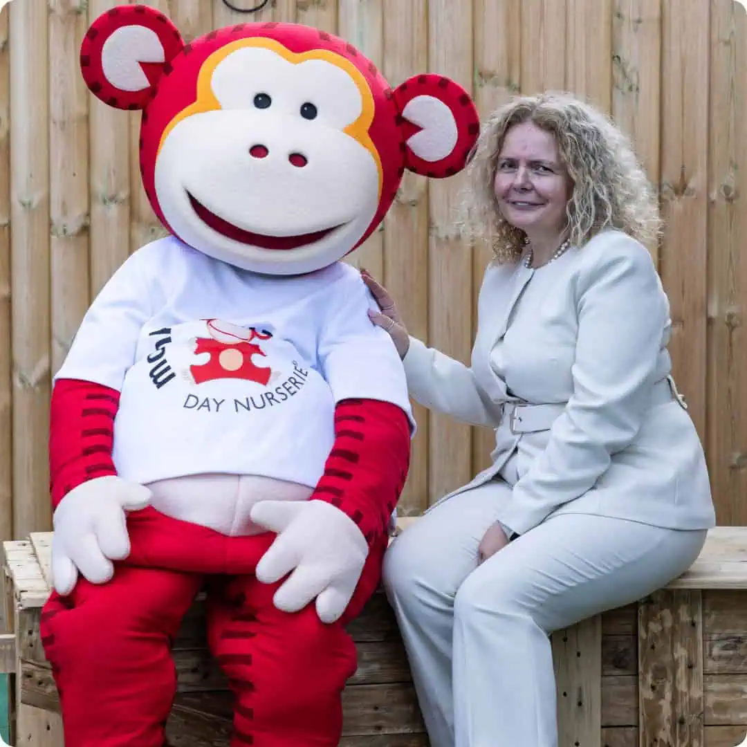 Monkey Puzzle Day Nursery Kingston Team Woman with Monkey Puzzle mascot at Kingston nursery.